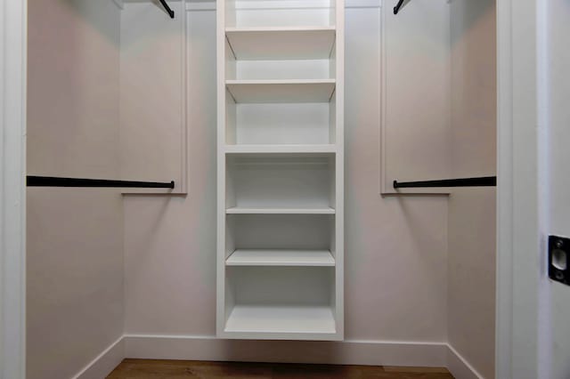 walk in closet with hardwood / wood-style floors