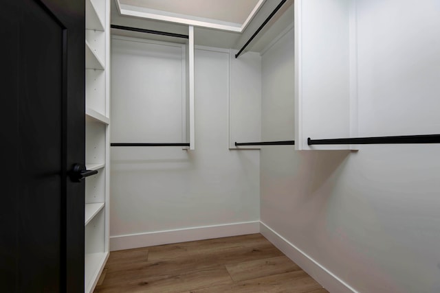 walk in closet featuring light hardwood / wood-style flooring