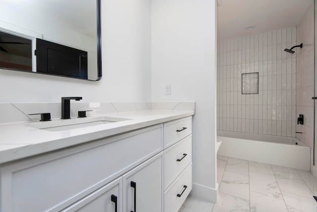 bathroom featuring vanity and tiled shower / bath combo