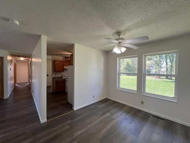 328 E 4th St, Willow Springs, MO 65793 - unfurnished room featuring plenty of natural light, a textured ceiling, dark wood-style floors, and ceiling fan