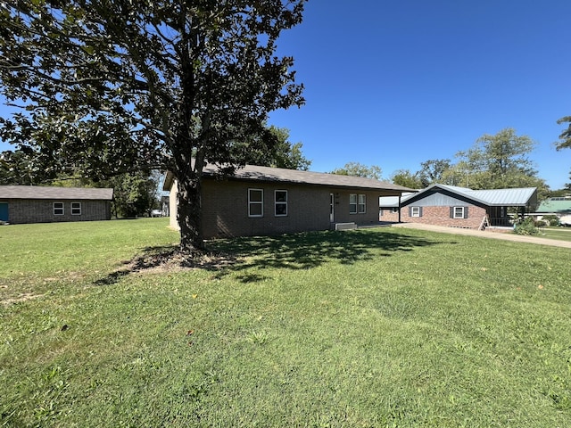 328 E 4th St, Willow Springs, MO 65793 - view of front of home featuring brick siding and a front yard