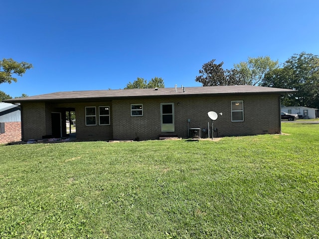 rear view of property with a lawn