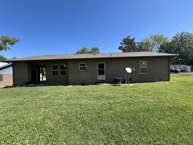328 E 4th St, Willow Springs, MO 65793 - rear view of property featuring a lawn, brick siding, cooling unit, and crawl space