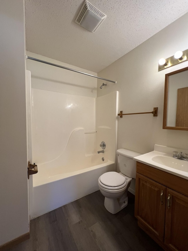 328 E 4th St, Willow Springs, MO 65793 - full bath featuring wood finished floors, visible vents, toilet, vanity, and a textured ceiling