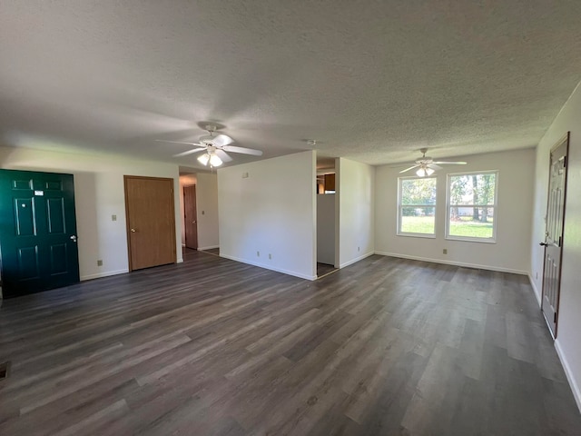 unfurnished living room with a textured ceiling, ceiling fan, and dark hardwood / wood-style flooring