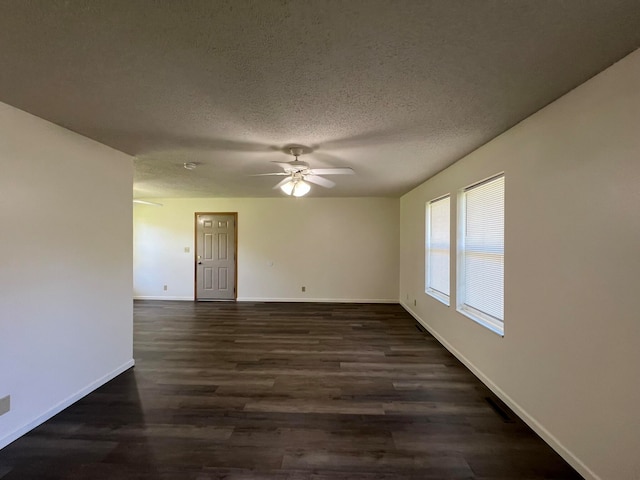 unfurnished room featuring ceiling fan, dark hardwood / wood-style floors, and a textured ceiling