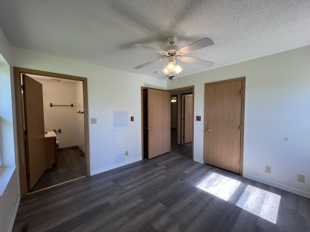 328 E 4th St, Willow Springs, MO 65793 - unfurnished bedroom with dark wood finished floors, baseboards, a textured ceiling, and visible vents