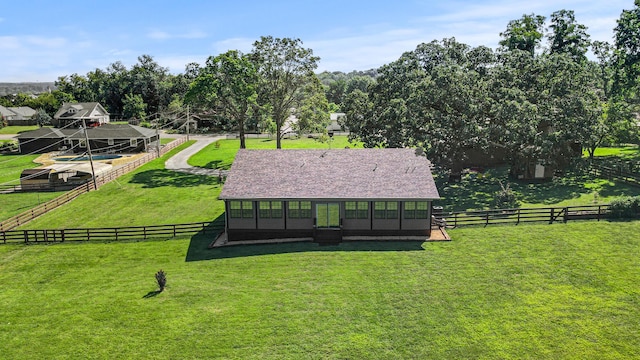 surrounding community featuring a yard and a rural view