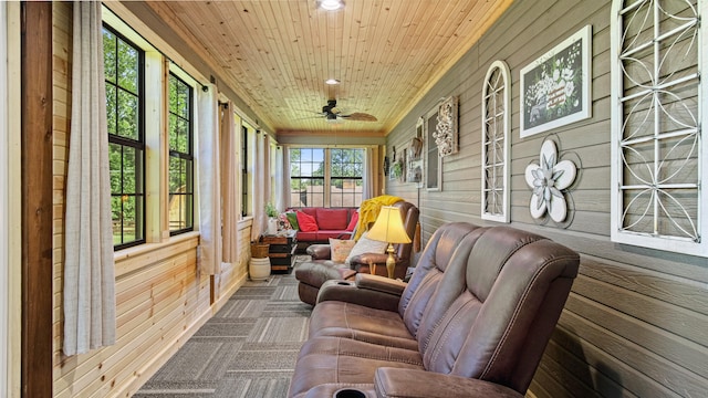 sunroom / solarium featuring wooden ceiling and ceiling fan