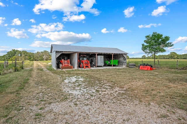 exterior space featuring a rural view and a yard