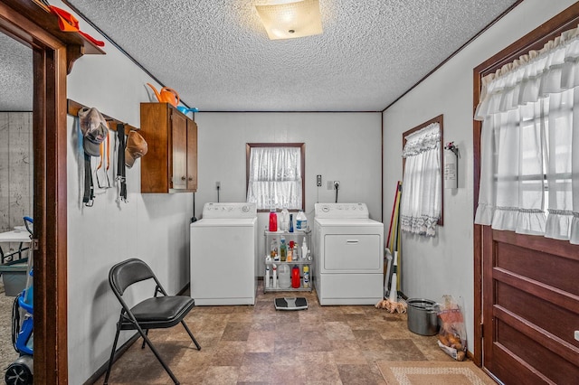 laundry area featuring cabinets, separate washer and dryer, and a textured ceiling