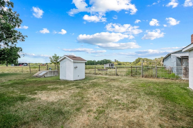 view of yard featuring a storage shed and a rural view