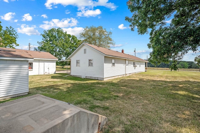 view of property exterior featuring a lawn and a patio