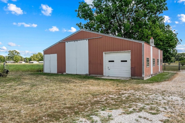 view of outdoor structure featuring a yard and a garage