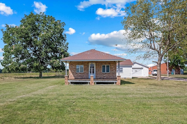 rear view of property featuring a lawn