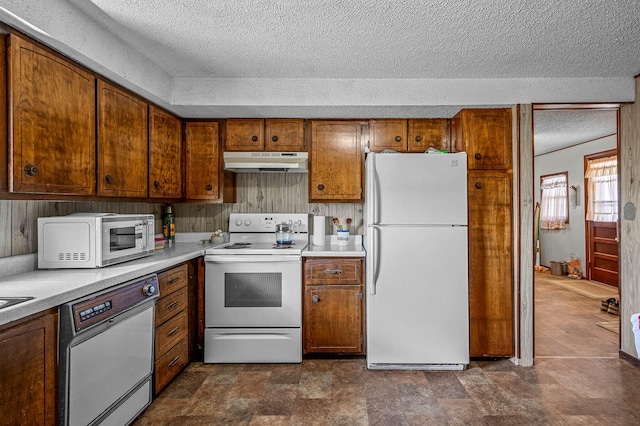 kitchen with a textured ceiling and white appliances