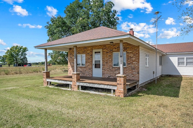 bungalow-style house featuring a wooden deck and a front yard