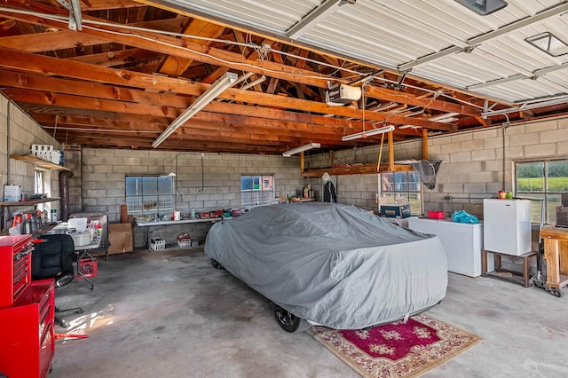 garage with washer / clothes dryer and a garage door opener