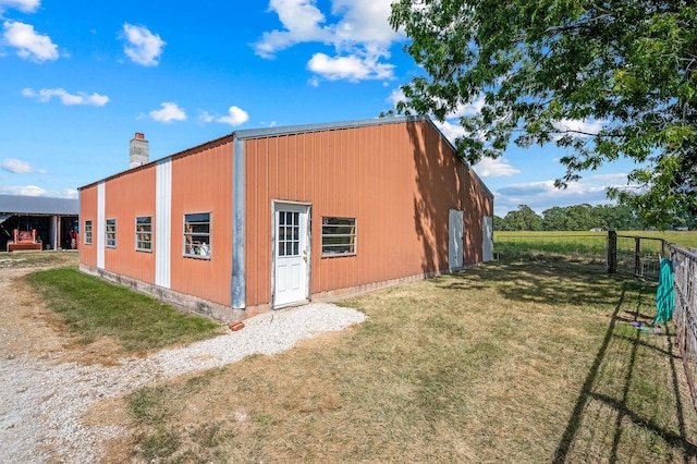 view of outbuilding featuring a yard