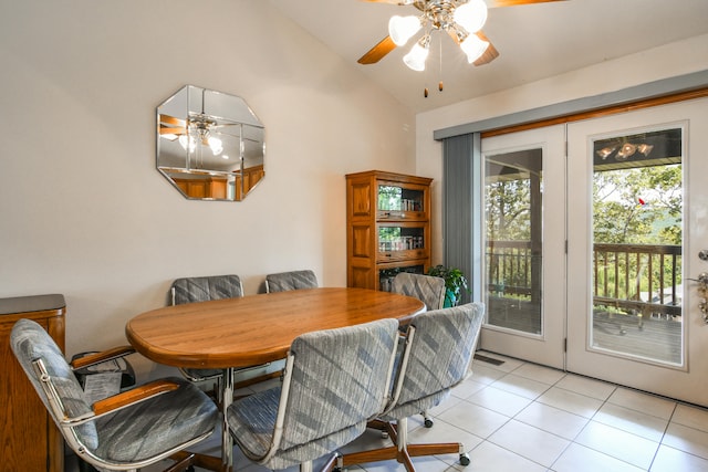 dining room featuring ceiling fan, light tile patterned floors, and high vaulted ceiling