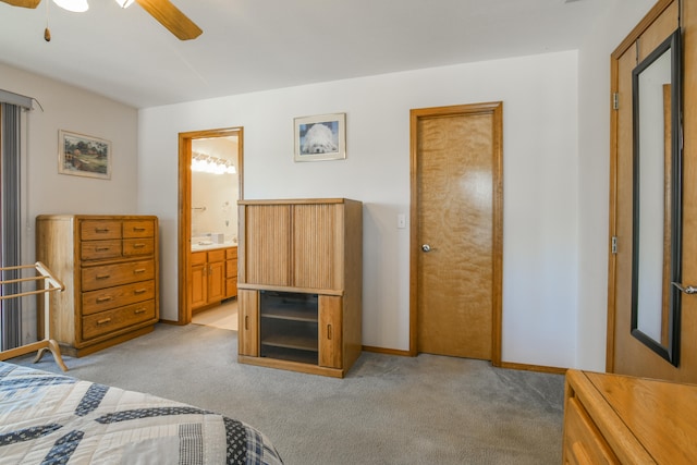 bedroom with light carpet, ensuite bath, and ceiling fan