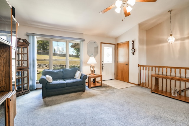 carpeted living room with a wealth of natural light, lofted ceiling, and ceiling fan