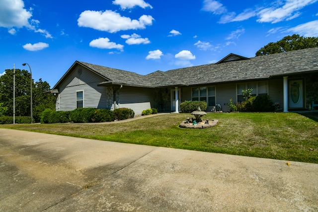 ranch-style house with a front lawn