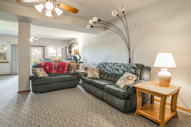 living room featuring ceiling fan, plenty of natural light, and carpet