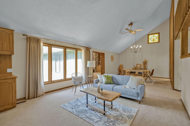 carpeted living room with ceiling fan with notable chandelier and vaulted ceiling