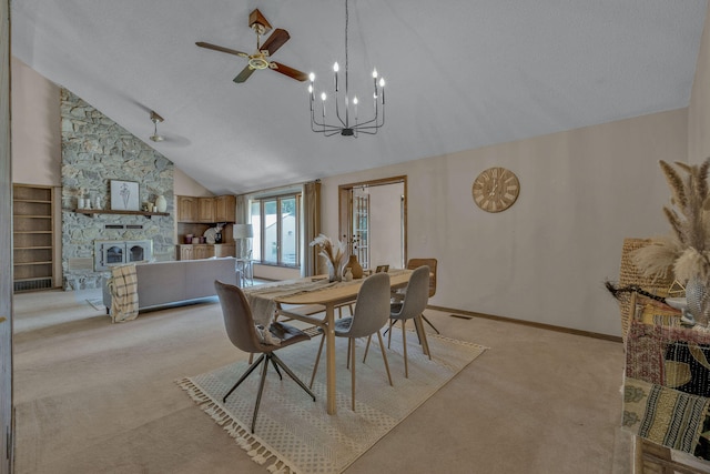 dining area with high vaulted ceiling, a textured ceiling, light carpet, a fireplace, and ceiling fan with notable chandelier