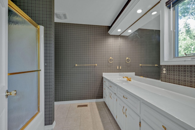 bathroom featuring vanity, tile patterned floors, and a shower with door