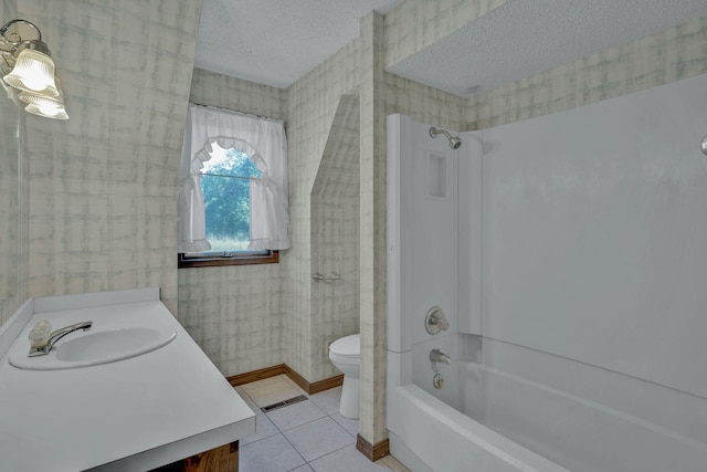 full bathroom with tile patterned floors, bathtub / shower combination, a textured ceiling, vanity, and toilet