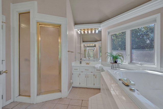 bathroom featuring plus walk in shower, vanity, and tile patterned floors