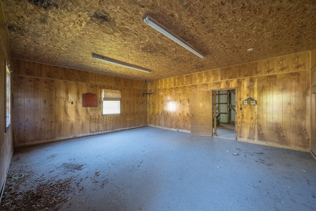 spare room featuring wooden walls