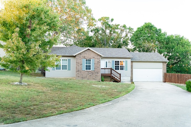 ranch-style home featuring a front yard and a garage