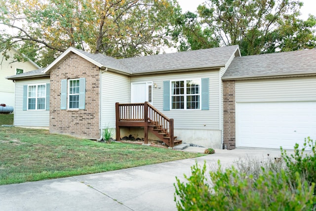 view of front of property with a garage and a front lawn