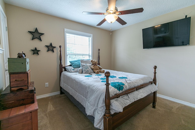 bedroom featuring ceiling fan, a textured ceiling, and carpet