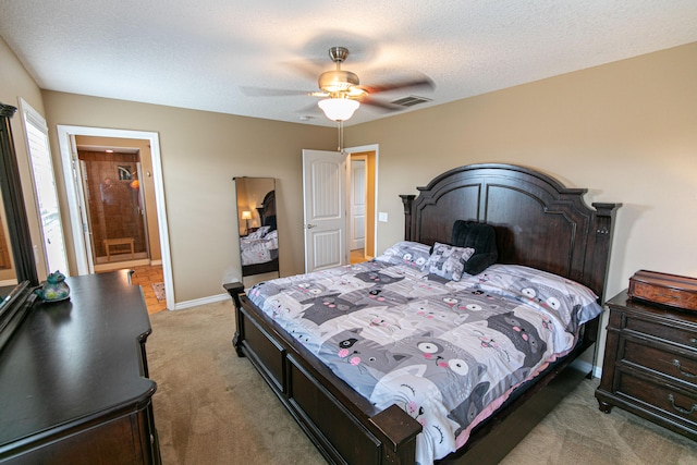 bedroom with ceiling fan, carpet, and a textured ceiling