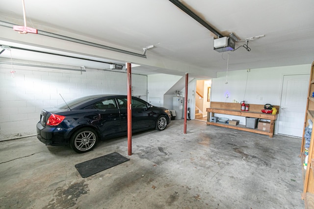 garage with a garage door opener and electric water heater