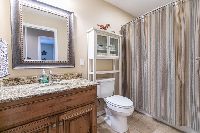 bathroom with toilet, tile patterned floors, a textured ceiling, vanity, and a shower with curtain