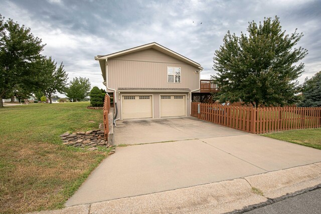 view of front of home featuring a garage and a front lawn