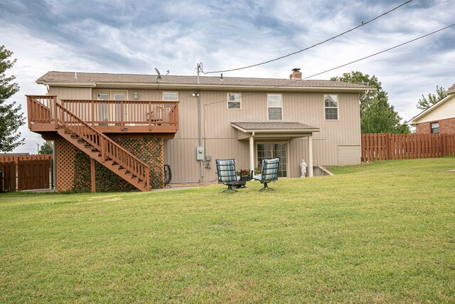 back of house with a lawn and a wooden deck