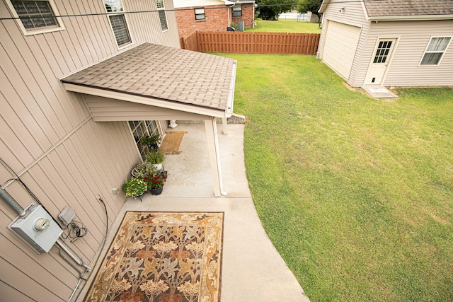 view of yard with a garage and a patio