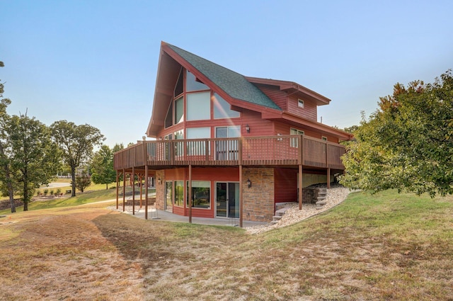 back of house with a yard and a wooden deck