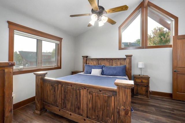 bedroom featuring ceiling fan, vaulted ceiling, dark wood-type flooring, and multiple windows