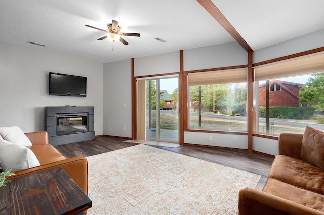 living room featuring dark wood-type flooring and ceiling fan