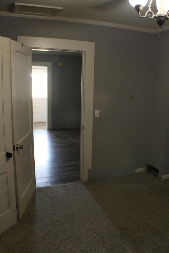 hall with ornamental molding and dark wood-type flooring