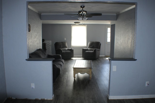 living room featuring ornamental molding, dark hardwood / wood-style flooring, and ceiling fan