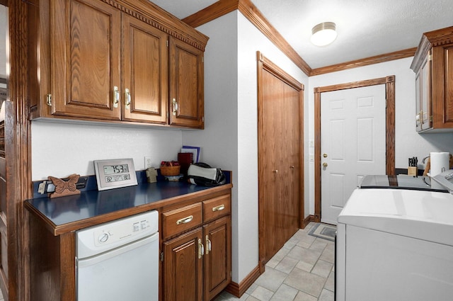 kitchen featuring white dishwasher, a textured ceiling, ornamental molding, and washing machine and dryer