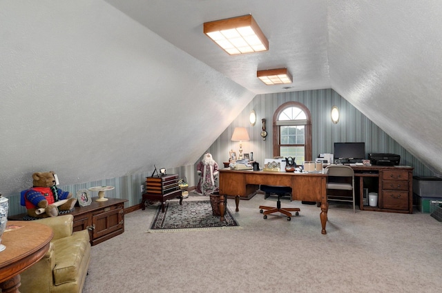 home office featuring a textured ceiling, vaulted ceiling, and carpet